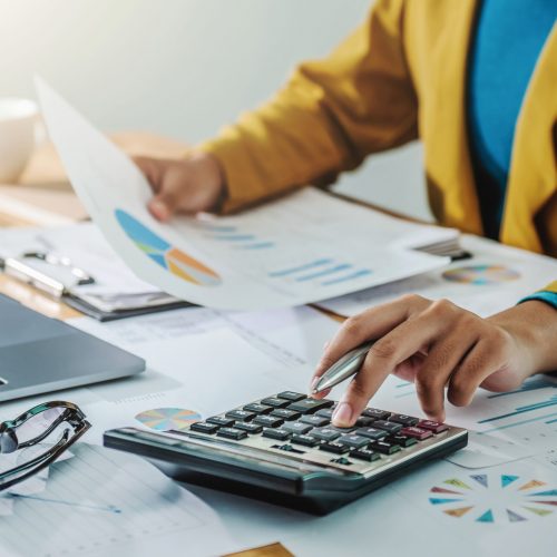 Business woman working in finance and accounting Analyze financial budget in the office